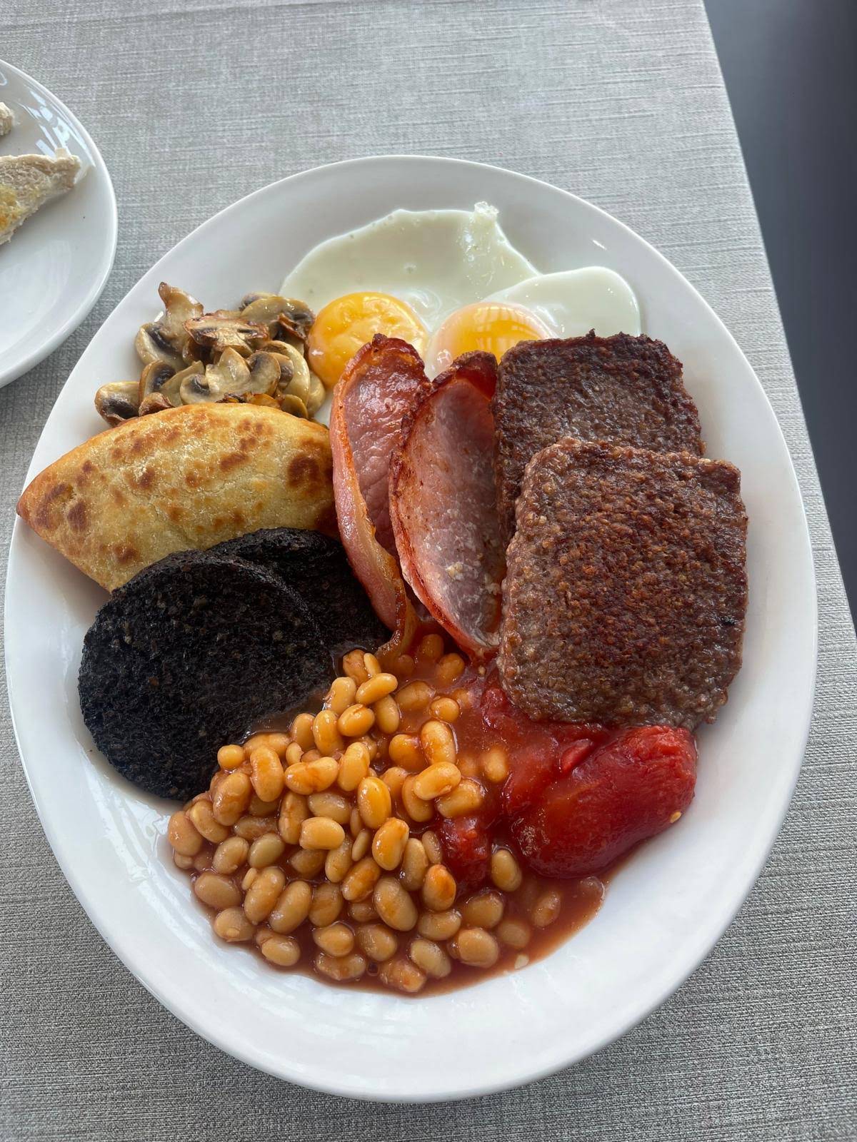 A full breakfast plate on a grey table, photographed by Jimmy’s Cafe